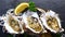 Cooked Oysters in Shells with Lemon and Garlic on Black Textured Slate, Top View