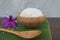 Cooked rice in bowl on green banana leaf and paddy in spoon and orchid .