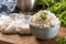 Cooked rice in a bowl with raw rice in plastick bags