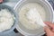 Cooked rice on plastic ladle in electric rice cooker