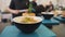 Cooked rice in a plate on a table, close up. Zooming camera. Traditional yellow rice with herbs and vegetables, healthy