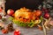 Cooked roasted Turkey with berries, vegetables and apples on wooden table background with black backdrop.