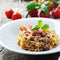 Cooked sardinain pasta fregola with tomato and sausage