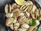 Cooked seafood clams in the iron pan portion with lemon and seasoning. close-up