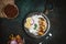 Cooked shrimps with lemon and onion on rustic metal tray with rice side dish on dark table