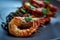 Cooked shrimps,prawns with seasonings on stone background. Fried shrimp with rosemary in a portioned frying pan on a dark table to