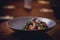 Cooked shrimps,prawns with seasonings on stone background. Fried shrimp with rosemary in a portioned frying pan on a dark table to