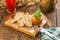 Cooked squash pasta in a jar with bread toast and berry drink on wooden table