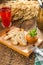 Cooked squash pasta in a jar with bread toast and berry drink on wooden table