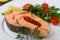 Cooked on steam salmon steak with vegetables