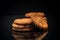 cooked sweet oatmeal cookies on black background