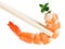 Cooked tiger shrimp with thyme twig in chopsticks