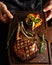Cooked Tomahawk long bone ribeye steak on a serving board