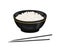 Cooked white rice in black bowl and chopsticks isolated on white background.