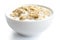 Cooked whole porridge oats with milk in white ceramic bowl isolated on white.