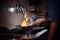 Cooker wearing gloves and apron frying flambe on a pan in a dark restaurant kitchen