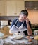 cookery lessons in the kitchen. Man reading a cookery book, Wearing an apron