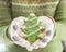 Cookie christmas tree gingerbread  with icing snowflake, winter homemade dessert snack in woman baker`s hand in winter glove