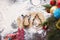 Cookie cutters herringbone and angel lie on shortcrust pastry on table covered with flour next to tree and candy