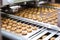 cookie dough being rolled out in an automated machine