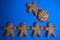 Cookie figures of men on blue background. Flat lay shot of freshly bakery gingerbread cookies man. Simple idea of community and