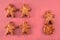 Cookie figures of men on pink background. Flat lay shot of freshly bakery gingerbread cookies man. Simple idea of community and