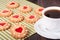 Cookie with heart jelly and cup of coffee bamboo napkin
