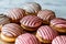 Cookie sandwiches with pink icing.