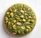 Cookie topped with pistachios, a green treat made with nuts