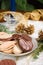 Cookies, blue candle, fir branch and pine cones on holiday napkin