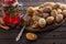 Cookies with caramel milk in the form of nuts on a wooden tray with a fruit drink with spices cinnamon and star anise