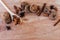 Cookies with chocolate, cinnamon and almonds with star anise star, white wooden spoon, on a light brown wooden board.