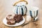 Cookies with chocolate and nuts, striped teapot, cup, lumpy sugar