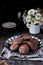 Cookies with cocoa, white chocolate and fried sesame seeds. Background chamomiles. Dark