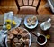 Cookies, coffee, milk, flowers on a wooden table.