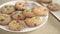 Cookies with colorful M&Ms chocolates close-up on a white plate