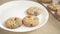 Cookies with colorful M&Ms chocolates close-up on a white plate