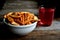 Cookies, cracker in a white ceramic bowl and stewed apples on a wooden table.