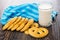 Cookies in form pretzels, napkin, milk on table. Top view