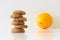 Cookies or fruit, cookies blurred, orange in focus, diet choice concept