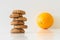 Cookies or fruit, cookies in focus, orange blurred, diet choice concept