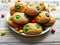 Cookies made from cream cheese with multi-colored candy m&m`s on a white wooden background