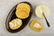 Cookies with milk in dish, teaspoon in bowl with condensed milk, cookie on table. Top view