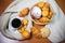 Cookies, pastries, coffee cup and gray scarf on wooden background