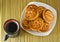 Cookies on a plate and a cup of black coffee. View from above