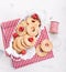 Cookies with sugar drops in a metal bowl with raspberries ready to decorate for holiday or gift