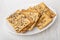 Cookies with sunflower seeds, flax-seeds, sesame in dish on wooden table