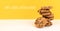 Cookies with yellow background and copy space and german text mit liebe gebacken, in english baked with love