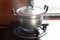 Cooking with aluminum pot on the gas stove in the kitchen.