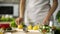 Cooking amateur making fresh salad at home kitchen, dressing with lemon juice